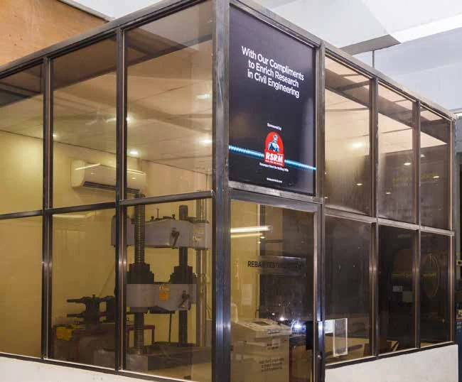 An engineering laboratory enclosure with an RSRM research-support sign